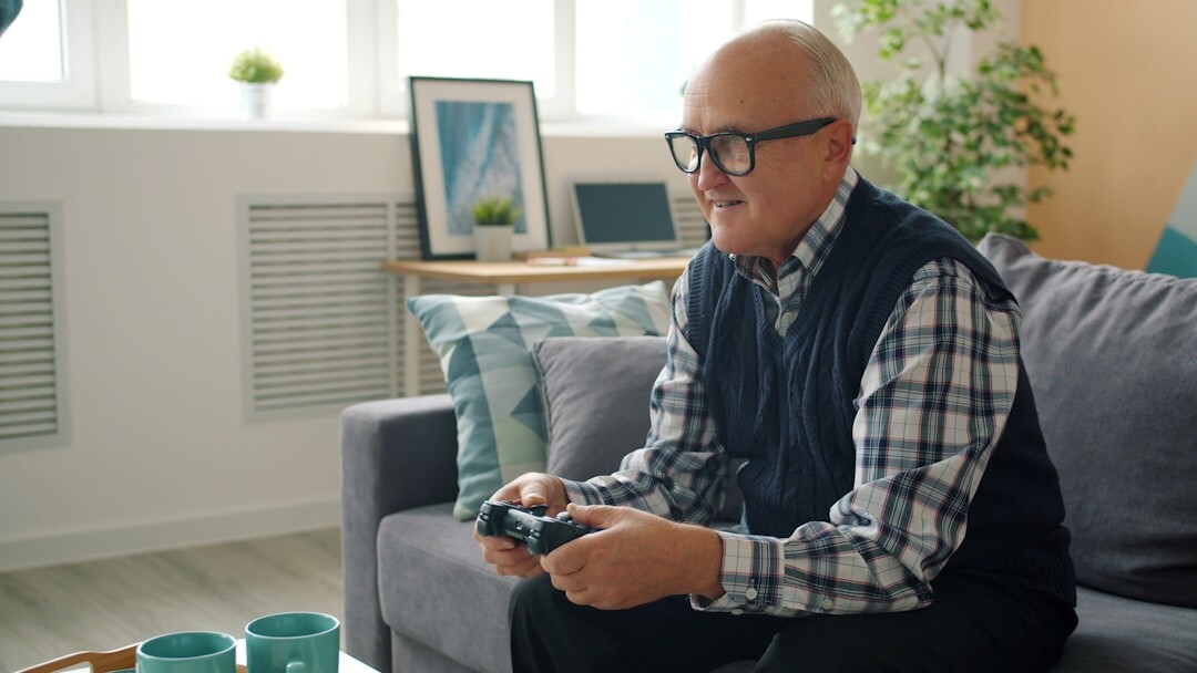 Senior man reading a newspaper at home with tea
